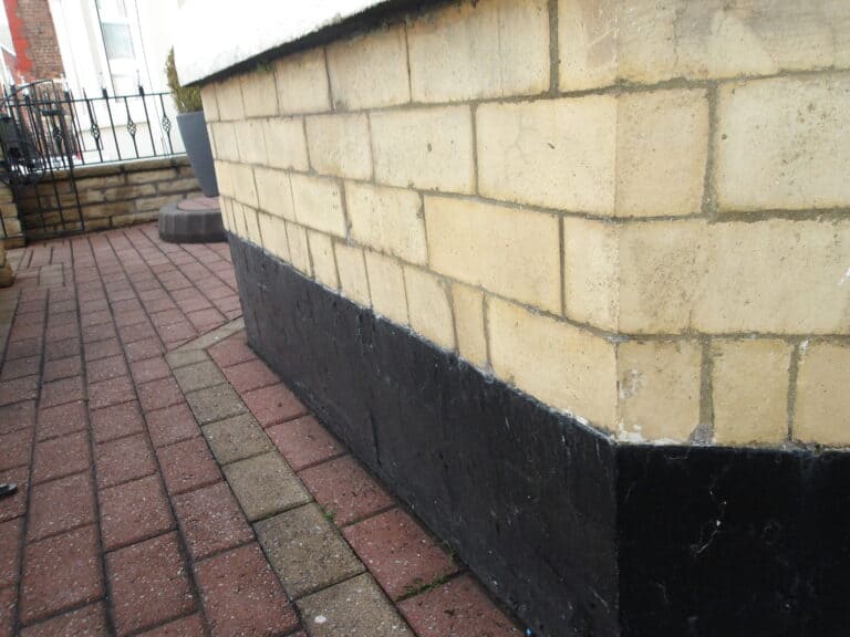 Brick wall inspection at Oakbridge Surveyors, UK.